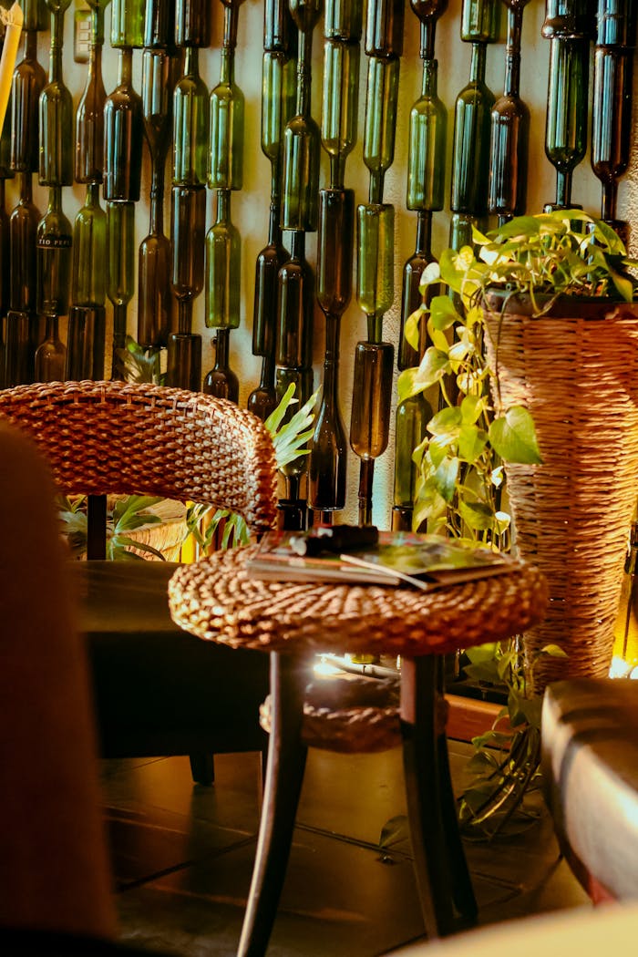 who-we-are Warm and inviting café interior with wicker furniture and recycled bottle wall in Tlaxcala, Mexico.